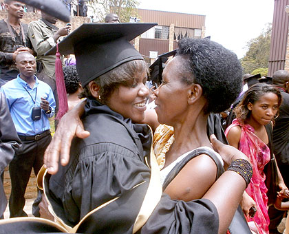 An excited mother congratulates her daughter at the NUR on Tuesday. The New Times / JP. Bucyensenge.