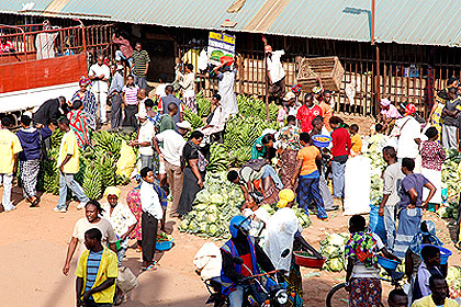 People buying food at Kimironko market. The New Times / T. Kisambira.
