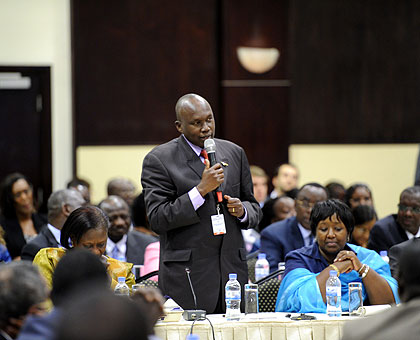 A participant makes a point during the opening day of the economic growth summit that is underway in Kigali. The New Times / Village Urugwiro