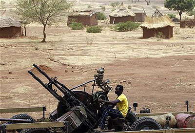 A SPLA-N fighter sits with an anti-aircraft weapon near Jebel Kwo village in the rebel-held territory of the Nuba Mountains in South Kordofan, May 2, 2012.