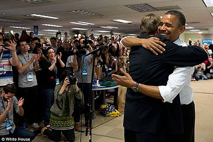 Minutes before: Obama is seen smiling as he hugs Jim Messina shortly before making his remarks. Net photo.