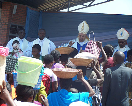 Pilgrims at Kibeho give their offerings during  the Assumption Day in August.  The New Times / JP Bucyensenge.
