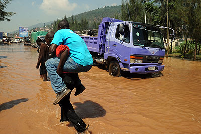 A man is carried across the flooded Nyabugogo. Disaster experts remain wanting on the Rwanda job market. The New Times / File.