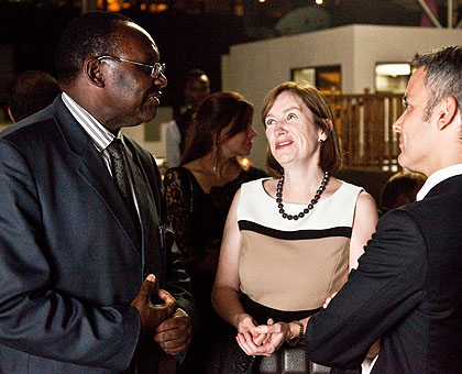 Minister of Trade and Industry Francois Kanimba (L) chatting with YPO members Nancy Reynolds, (C) and Yariv Cohen during the dinner at Manor Hotel. The New Times / T.Kisambira.