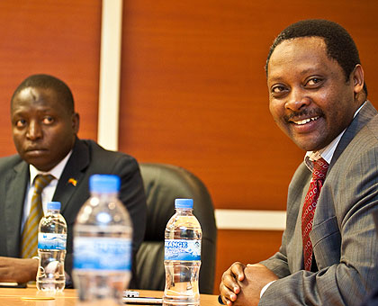 Prof. Shyaka Anastase (R), CEO, RGB, together with David Bahati, the Head of Ugandan delegation.     The New Times / T. Kisambira.