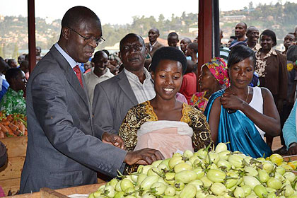 Minister Murekezi looking at commodities in Gatsata new market. The New Times / T. Ishimwe.