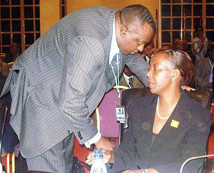 Foreign Affairs Minister Louiseu00a0 Mushikiwabo confers with Rwandau2019s Permanent Representative to the United Nations and State Minister in Charge of Cooperation Ambassador Eugu00e8ne-Richard Gasana, during the ICGLR Heads of State summit in Kampala yesterday. The New Times / Gashegu Muramira.