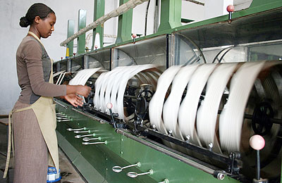 A worker spins raw silk yarn in a factory owned by textile firm Utexrwa in Kigali. Government hopes to improve  the countryu2019s industrial sector.