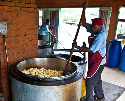 A cook preparing a meal of Irish Potatoes at Riviera High School u2013 for the teachers marking the national exams. The New Times / T. Kisambira.
