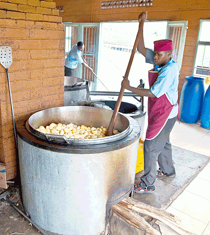 A cook preparing a meal of Irish Potatoes at Riviera High School for the teachers marking the national exams. At least 195 teachers were treated for suspected food poisoning after eating meals served at the school, health officials at the school clinic confirmed Monday. The Sunday Times / T. Kisambira.