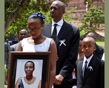 GONE TOO SOON: Husband to the late Aloisea Inyumba, Richard Masozera, with their children Nicole, 16, and Noah, 8, at the funeral yesterday. The New Times / Timothy Kisambira.