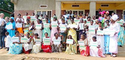 Some of the women who graduated pose with their certificates in a group photograph. The Sunday Times/G. Mugoya.