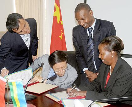 Foreign Affairs Minister Louise Mushikiwabo (R) and Chinese Ambassador to Rwanda Shu Zhan sign the agreements on Friday.  The New Times / John Mbanda.