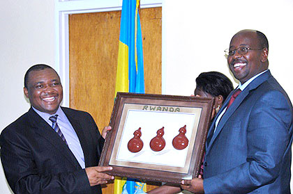Local Government Minister James Musoni (R) and Lesotho Deputy Premier Mothetjoa Metsing exchange gifts on Friday. Net photo.