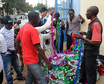 People buy Christmas decor in downtown Kigali yesterday. The New Times/John Mbanda.