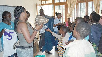 Faith Uwantege and her team give kids Christmas presents. The New Times Sam K Nkurunziza.