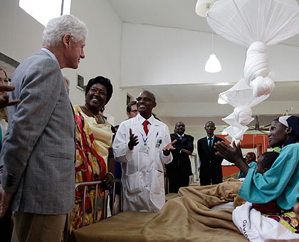 Former US President Bill Clinton is welcomed by patients at the Butaro Cancer Centre in Burera district in July 2012. The New Times / File.