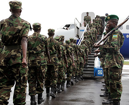  RDF soldiers board a Darfur-bound RwandAir Plane at Kigali International Air port in the past. The New Times / T.Kisambira. 