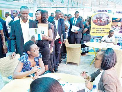 Job seekers line up at the stall of Fina Bank during the Job day at Kigali Public Library yesterday.   The New Times / T. Kisambira.