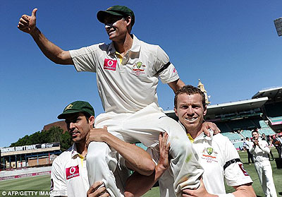 Peter Siddle (R) and Mitchell Johnson carry Michael Hussey off the field. Net photo.