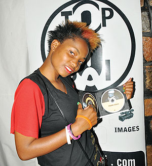 Young Grace with her CD. The New Times/P. Muzogeye.