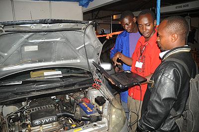 An exhibitor explains how to monitor an engine  using a computer during the recent TVET Expo. The New Times / File.