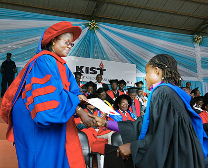 Tuyizere receives her certificate from Dr Mujawamaliya during the ceremony yesterday. The New Times/  Timothy Kisambira