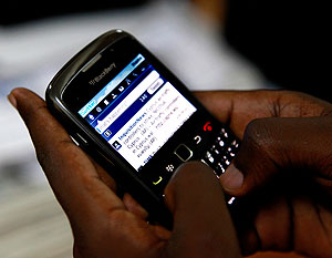 A mobile phone user checking his Twitter account. All phone owners must register their SIM cards with six months.  Net photo.