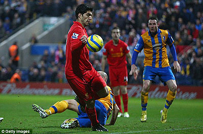 Luis Suarez was involved in controversy recently with this handball against Mansfield. Net photo.