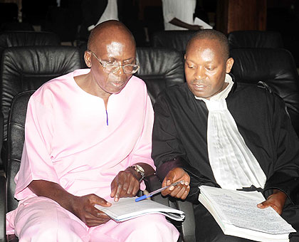 Mugesera consults with his lawyer Felix Rudakemwa during an earlier proceeding. The New Times/ File