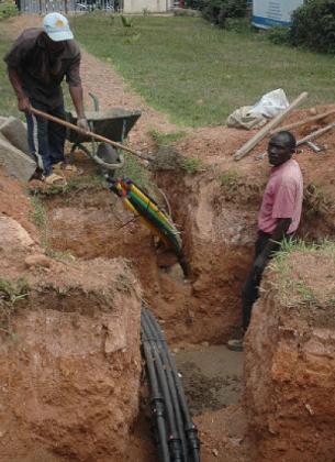 Workers laying an optic cables in Kigali. Such infrastructure is vital for e-tendering. The New Times / File photo.