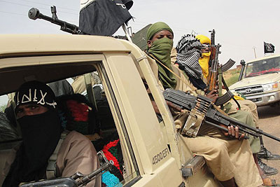 Fighters of the Islamic group Ansar Dine stand guard at the Kidal Airport in northern Mali last year.  Net Photo