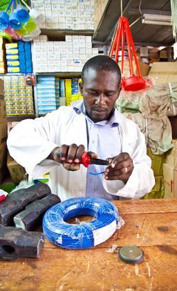 Philbert Zimulinda the head of Import section in RBS tasting the electrical wire cables at Quencaillerie hardware shop in Nyarugenge. The New Times  / T. Kisambira