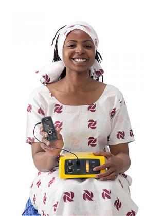 A woman displays the multipurpose  solar system. The New Times / courtesy.