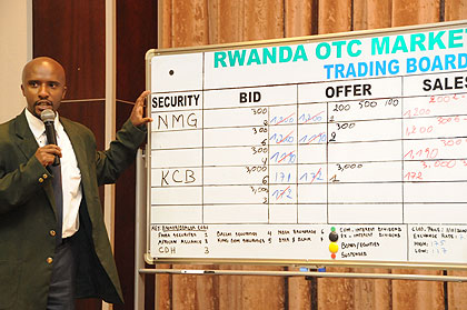 A broker at the bourse in an earlier trading session. Bank of Kigali has joined other eight brokers at the RSE. The New Times/File.