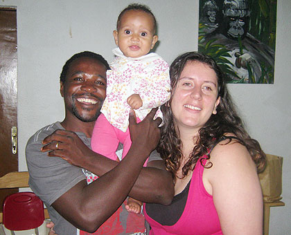 Usabyamahoro and Rebecca hoist their nine-month-old baby, Keza. The New Times/Courtesy.