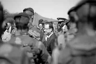 French President Francois Hollande addresses the troops at the airport following his two-hour-long visit to Timbuktu, Mali, Saturday Feb. 2, 2013.