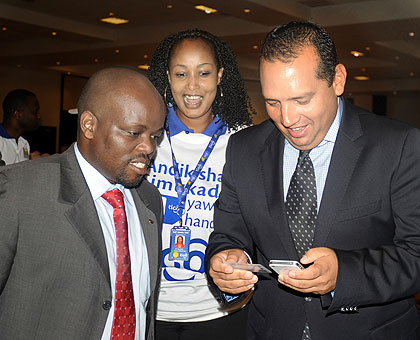 ICT minister Nsegimana (L) registers his SIM card with Tigo CEO Diego Camberos, yesterday. The  minister urged mobile phone users to register before the July 31 deadline.  The New Times/ J. Mbanda
