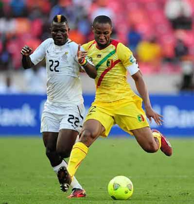 Mali captain Seydou Keita (left) and Ghanau2019s midfielder Mubarak Wakaso battle in the group game, which the Black Stars won 1-0. Net photo.