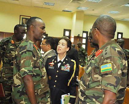 Kayonga (L) shares a light moment with Lt Col Gwyn A. Carver, the military attache at the US embassy in Kigali, and Col. Peter Kalimba, who is in charge of training in RDF. The New Times/ Courtesy. 