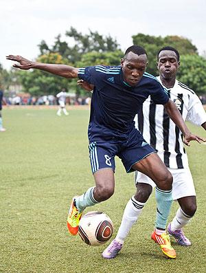 Meddie Kagere shields the ball from APRu2019s defender Heritier Turatsinze yesterday in Kicukiro.  Sunday Times / T. Kisambira.