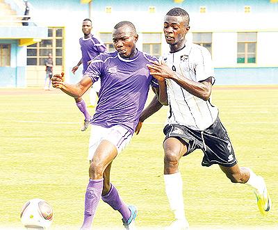 Striker Barnabe Mubumbyi vying for the ball against Vitalu2019ou2019s defender Idi Jumapili yesterday at Amahoro stadium.  Sunday Times / Plaisir Muzogeye.