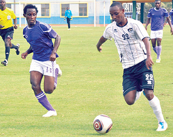 APR's Jean Claude Iranzi attempts to dribble past Vital'O's D'Amour Nkurunziza in Saturday's Champions League clash.  The New Times / Plaisir Muzogeye.
