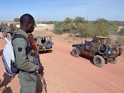 Malian soldiers watch a French military unit near Diabaly on Jan. 23; Polls are expected to unite the West African nation  Net photo.