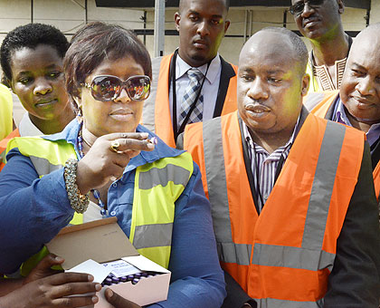 Dr Binagwaho inspects samples of the vaccine in Kigali at the weekend. The New Times/  John Mbanda.