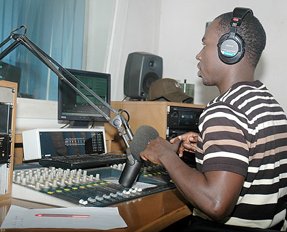 A DJ in a studio of a local radio station. The New Times/ File.
