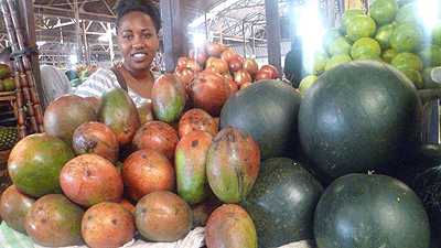 A fruit seller in Kimironko Market. Prices were stable last week. The New Times / Seraphine Habimana.