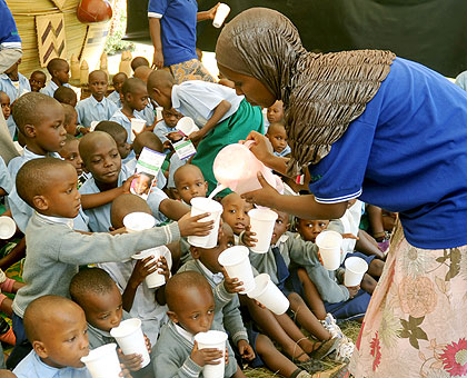 Children receive milk under the programme. The New Times/ File. 