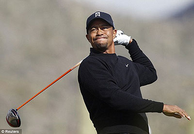 Tiger Woods had a poor day at the office, skewing this drive off target. Net photo.