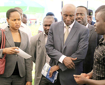 PS Mbabazi (L) and other officials tour ICT stands at the Nyamasheke campaign. The New Times/  Jean P. Bucyensenge.